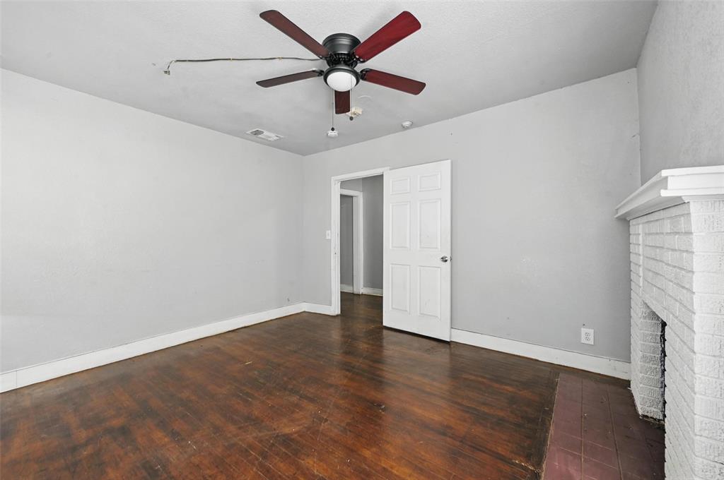 2813 East Rosedale Street Fort Worth, TX 76105 - Photo 7 of 23 an empty room with wooden floor and a ceiling fan