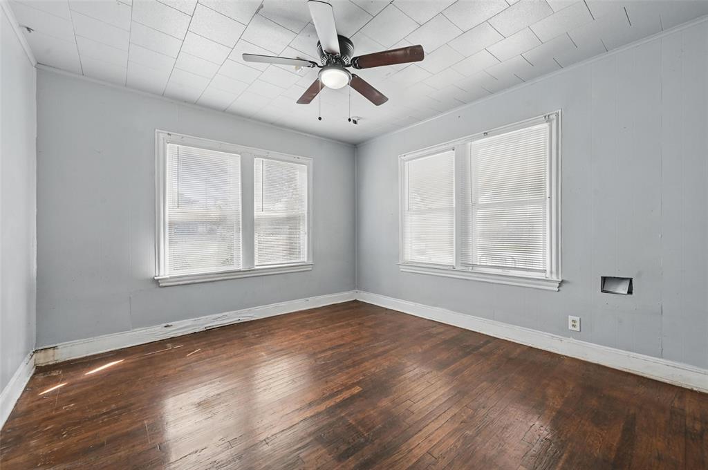 2813 East Rosedale Street Fort Worth, TX 76105 - Photo 8 of 23 a view of an empty room with wooden floor and a window