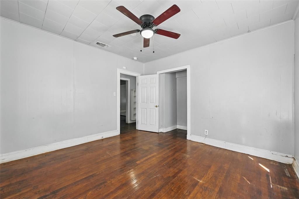 2813 East Rosedale Street Fort Worth, TX 76105 - Photo 9 of 23 an empty room with wooden floor and ceiling fan