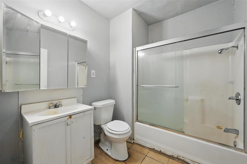 2813 East Rosedale Street Fort Worth, TX 76105 - Photo 10 of 23 a bathroom with a toilet sink and shower