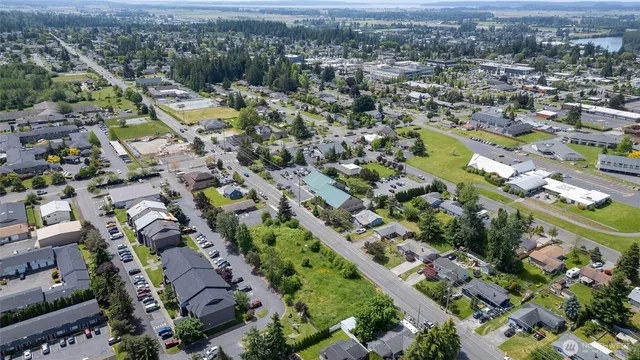 an aerial view of city lake and residential houses with outdoor space and trees