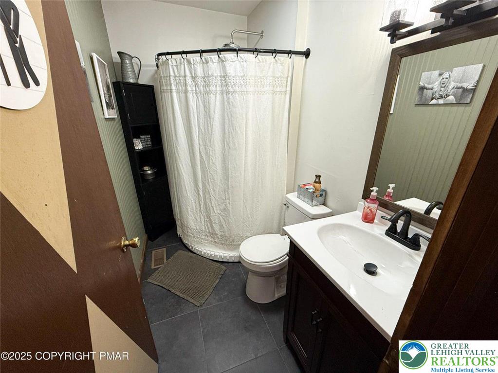 229 Deer Path Kunkletown, PA 18058 - Photo 25 of 29 a bathroom with a sink a toilet a mirror and shower curtain