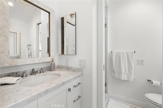 a bathroom with double vanity sink and a mirror