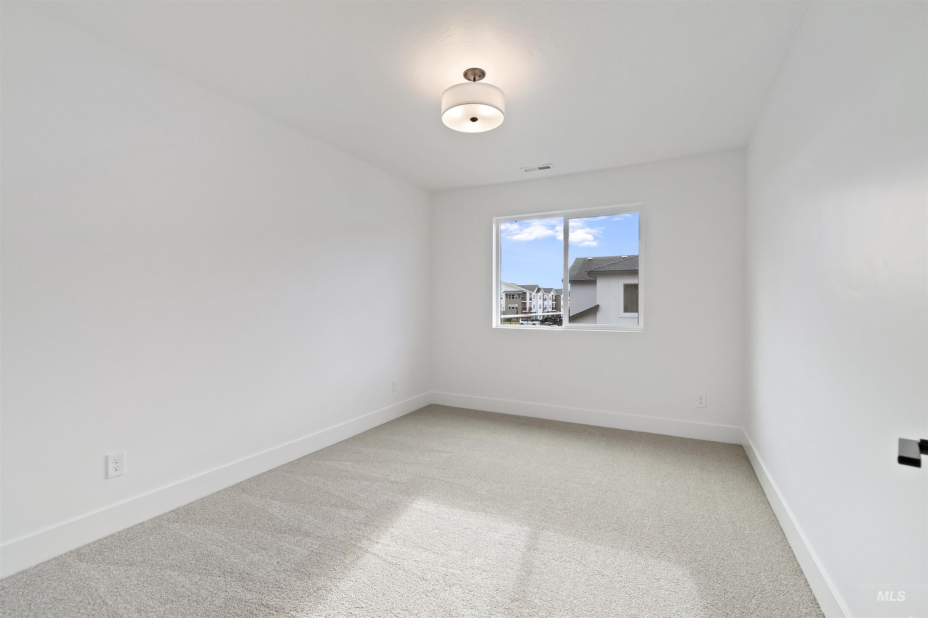 764 South Calhoun Lane Star, ID 83669 - Photo 33 of 48 Spare room with light colored carpet and baseboards