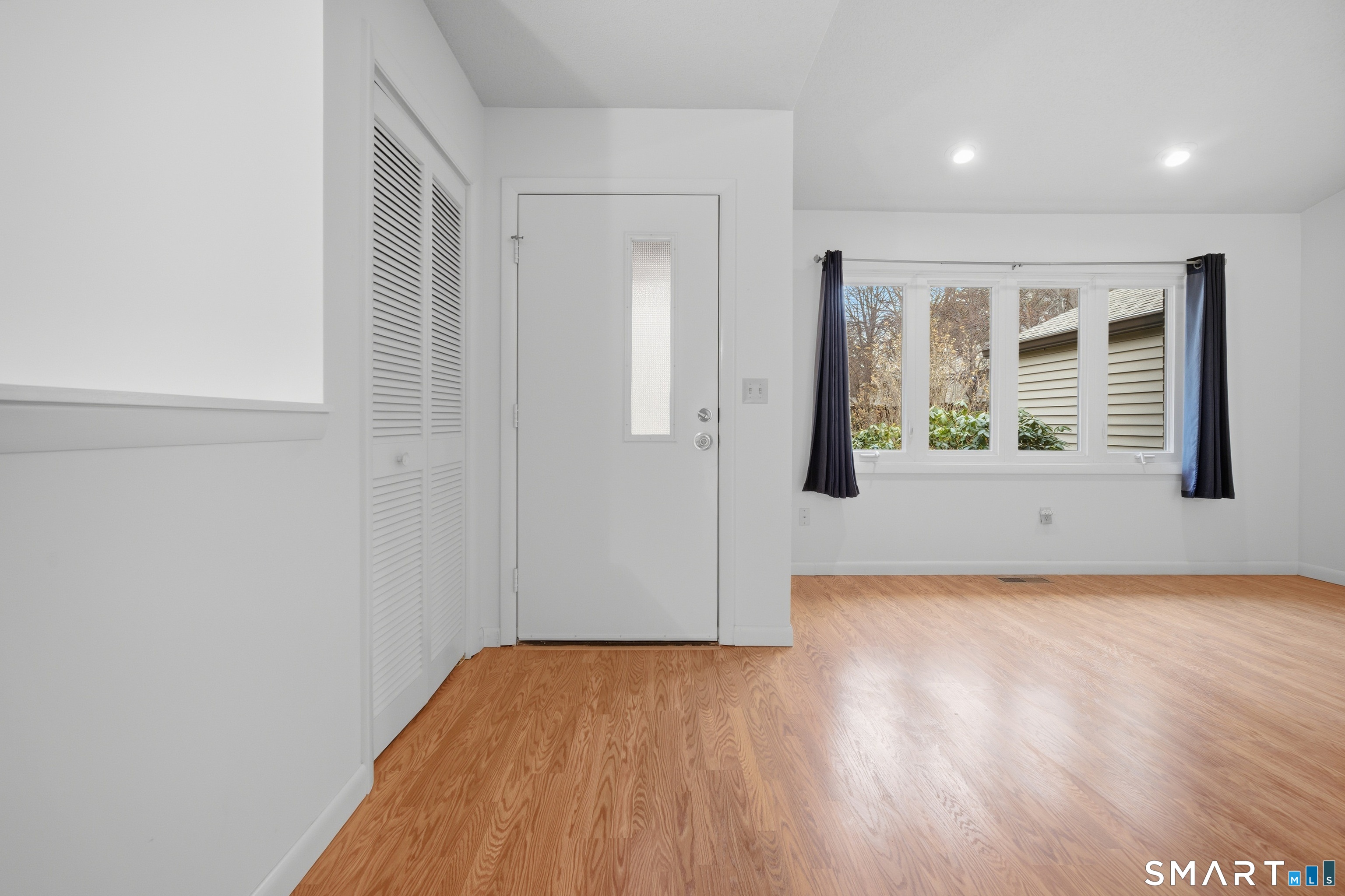 449 South Main Street, Unit 90 Manchester, CT 06040 - Photo 4 of 39 an empty room with wooden floor and windows