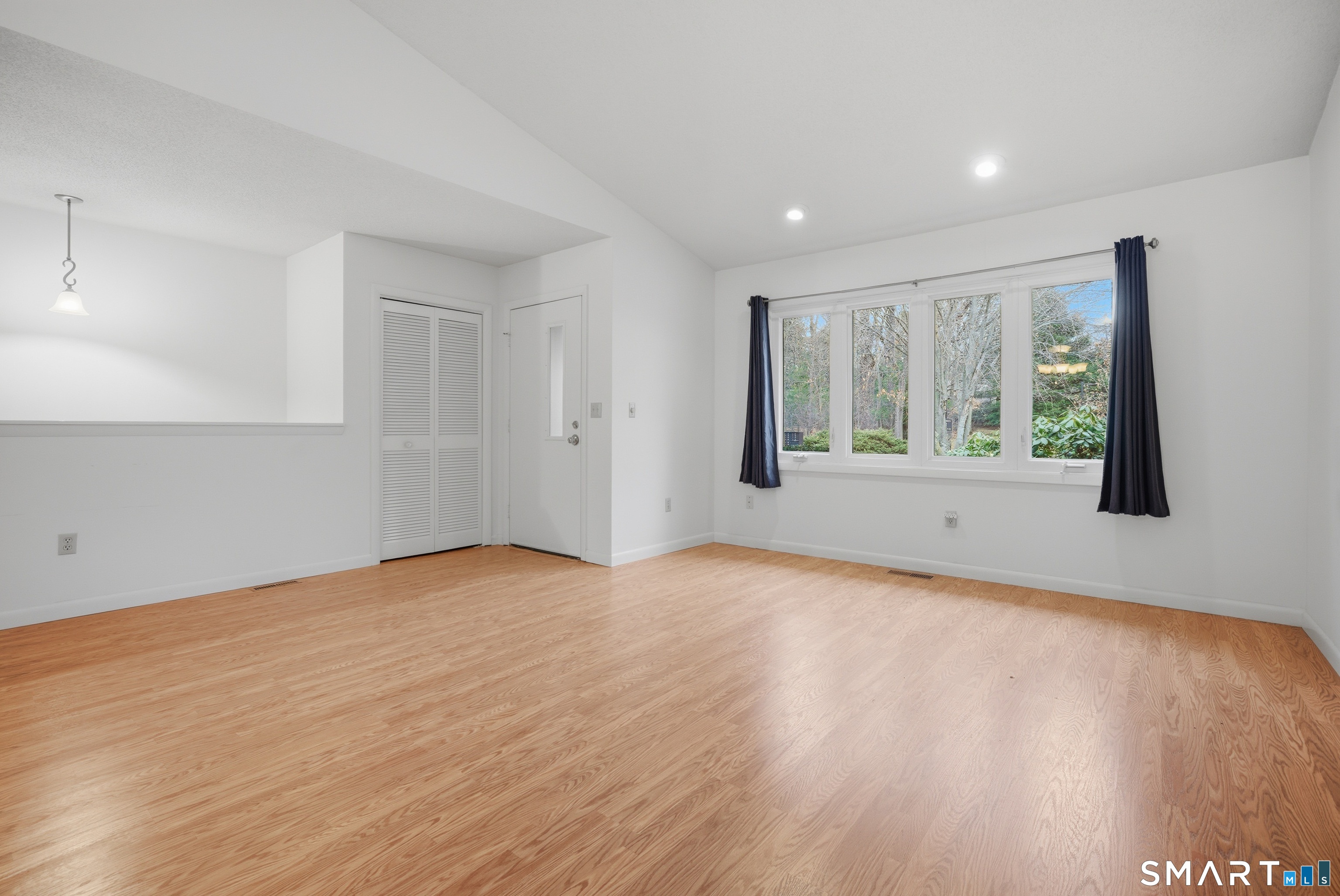 449 South Main Street, Unit 90 Manchester, CT 06040 - Photo 6 of 39 a view of an empty room with wooden floor and a window
