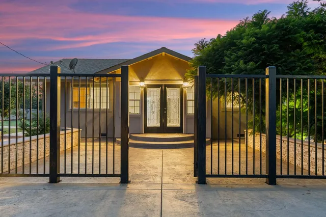 a view of a house with a iron gate