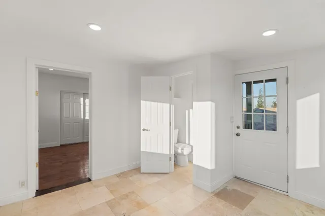 an empty room with windows and entrance