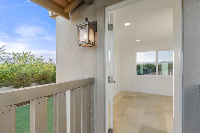 a view of balcony with wooden floor