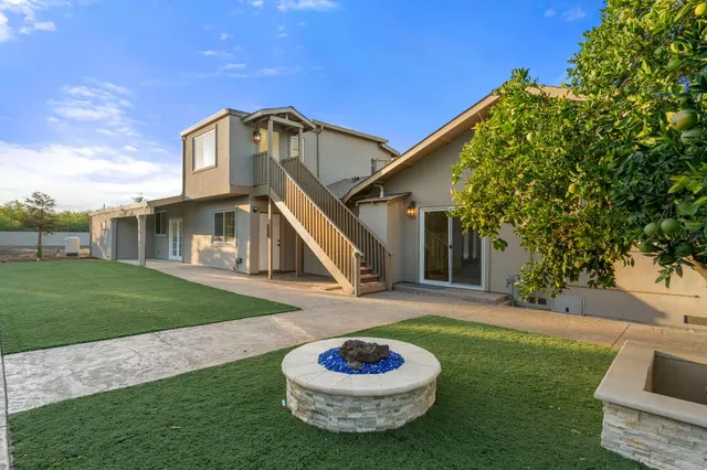 a view of a house with a backyard
