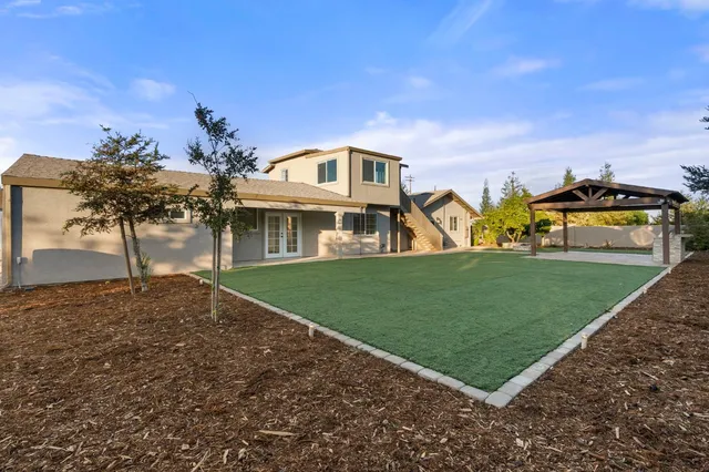 a front view of a house with a garden and yard
