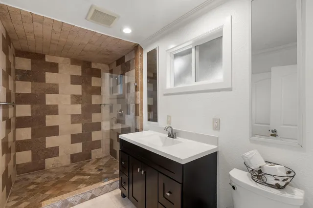 a bathroom with a sink toilet and shower