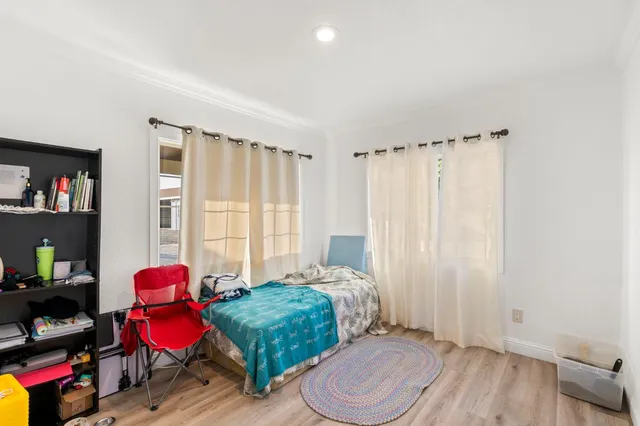 a bedroom with furniture and a chair