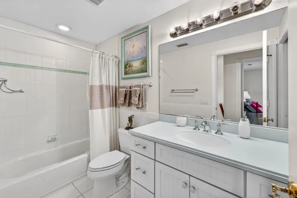 a bathroom with a sink double vanity granite toilet tub and shower