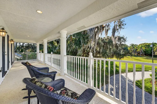 a view of a roof deck with wooden fence and a bench