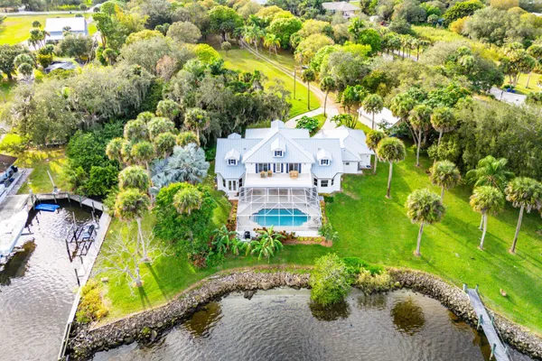 an aerial view of a house with a yard swimming pool outdoor seating and yard
