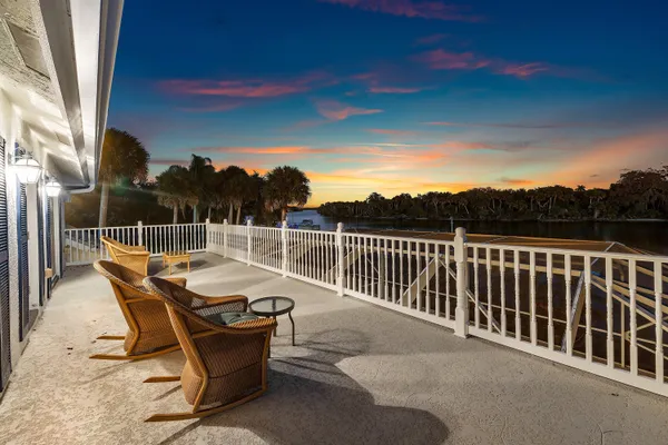 a view of a lake with a table and chairs