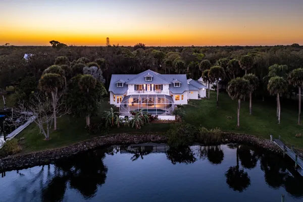an aerial view of a house with a lake view