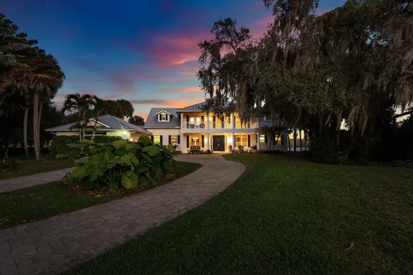 a view of a park with a house in the background