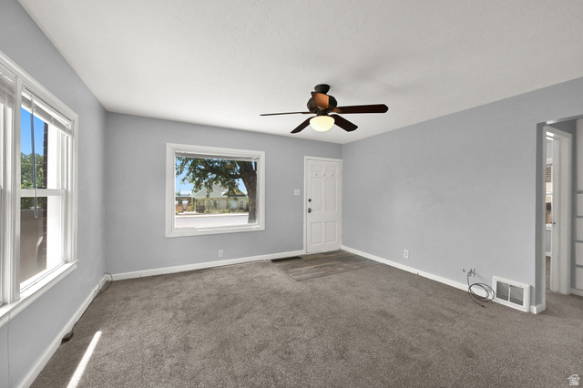291 800 East Bountiful, UT 84010 - Photo 3 of 20 Living area featuring light gray walls and dark gray carpet