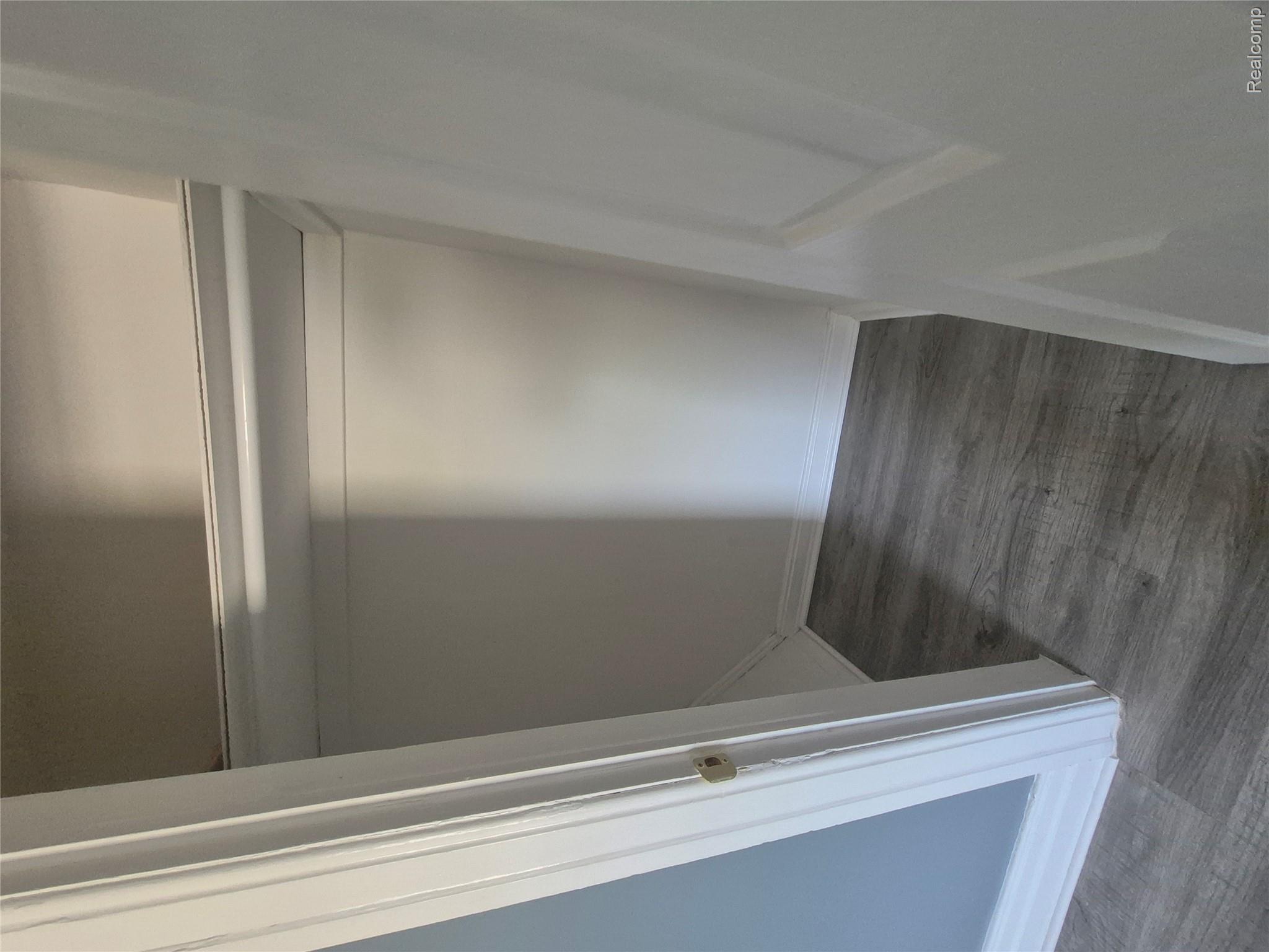 16758 Frazho Road Roseville, MI 48066 - Photo 37 of 53 Closet featuring wood-finish flooring, white walls, built-in shelving, and a hanging rod