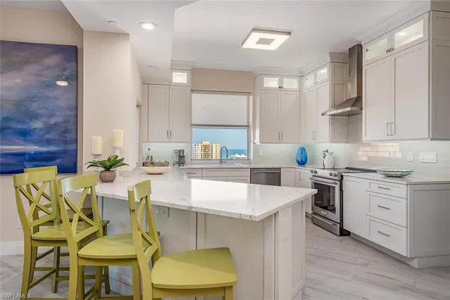 a kitchen with a table chairs sink and cabinets