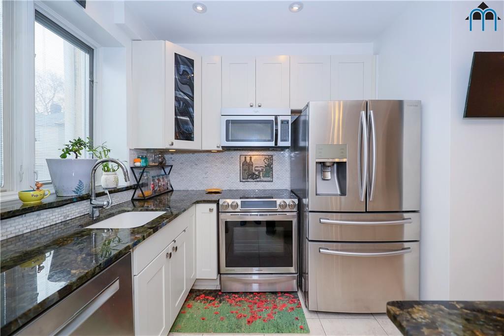 8909 Ridge Boulevard Brooklyn, NY 11209 - Photo 11 of 31 a kitchen with stainless steel appliances granite countertop a sink stove and refrigerator