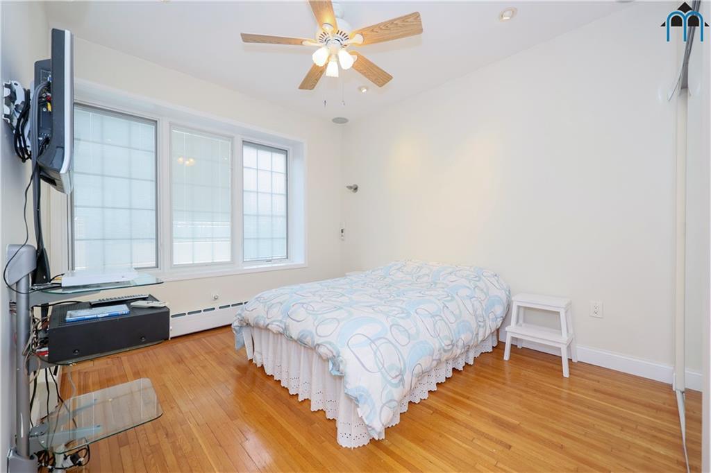 8909 Ridge Boulevard Brooklyn, NY 11209 - Photo 17 of 31 a spacious bedroom with a bed and a dresser