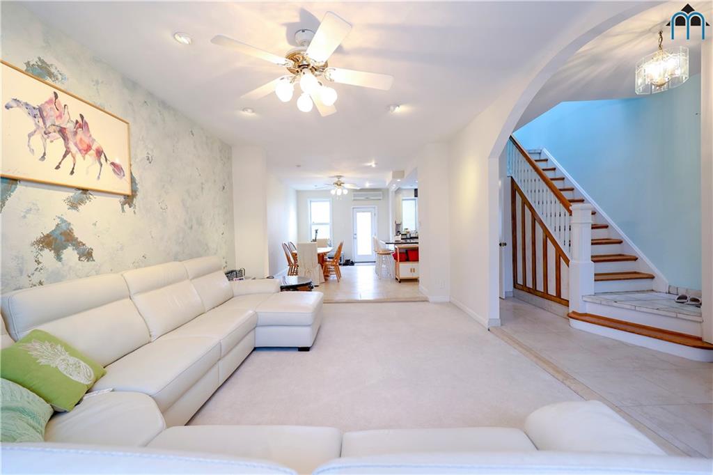 8909 Ridge Boulevard Brooklyn, NY 11209 - Photo 8 of 31 a living room with furniture and a chandelier