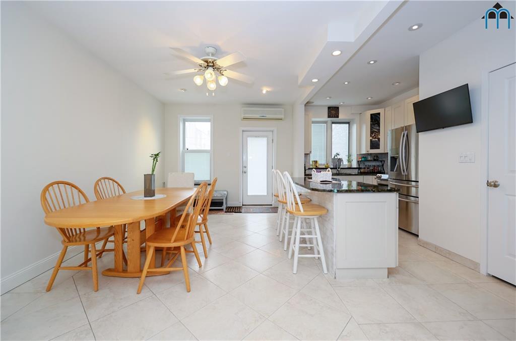 8909 Ridge Boulevard Brooklyn, NY 11209 - Photo 10 of 31 a dining room with furniture a chandelier and kitchen view