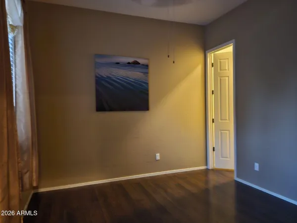 a view of a hallway with furniture and a bathroom