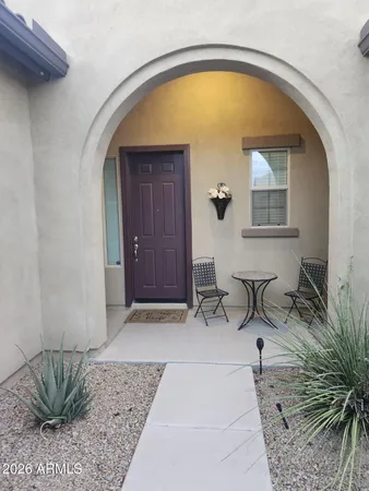 a living room with furniture kitchen view and a window