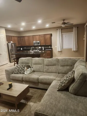 a living room with furniture and kitchen view