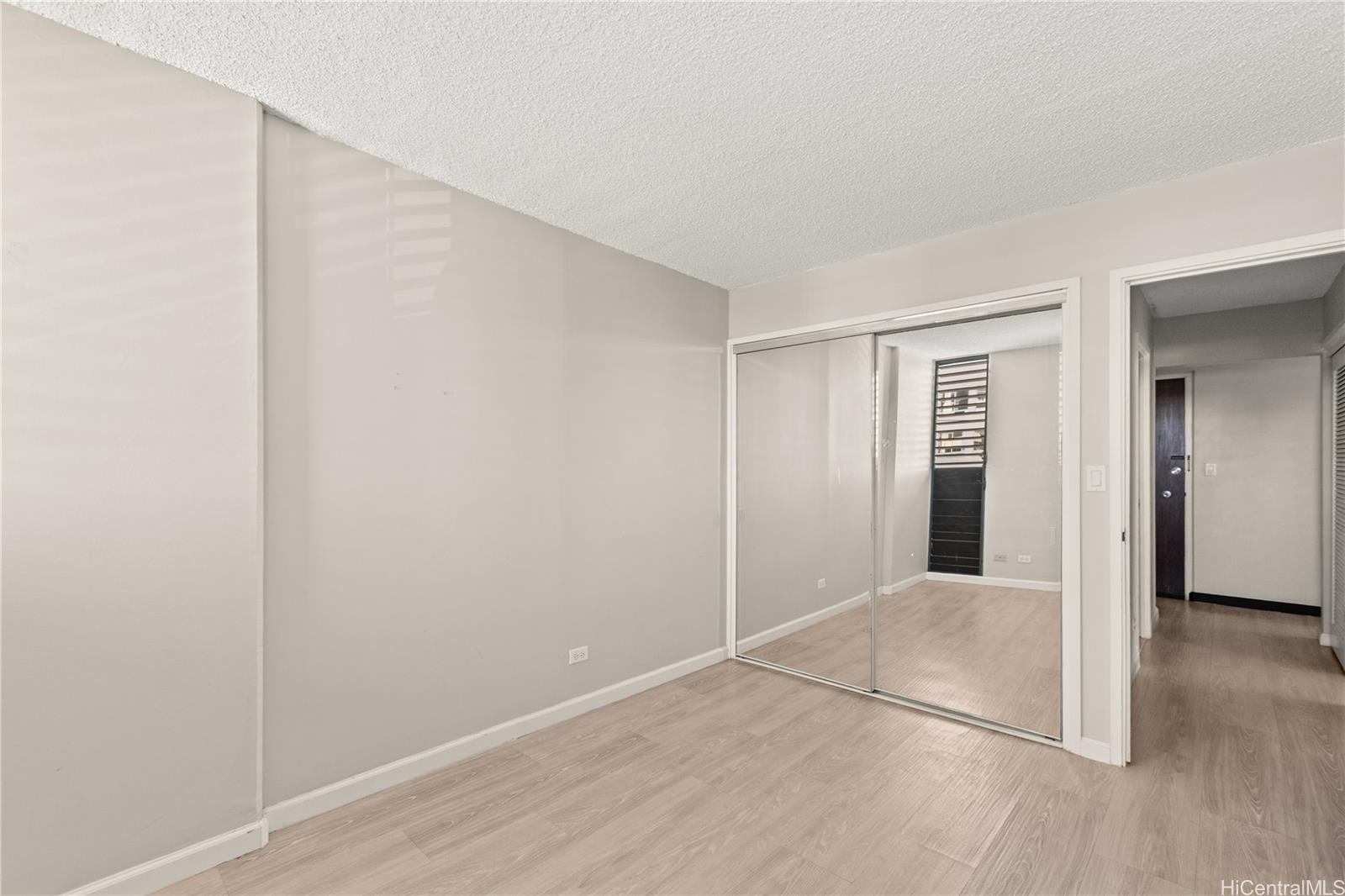 1069 Spencer Street, Unit 101 Honolulu, HI 96822 - Photo 11 of 19 wooden floor in an empty room