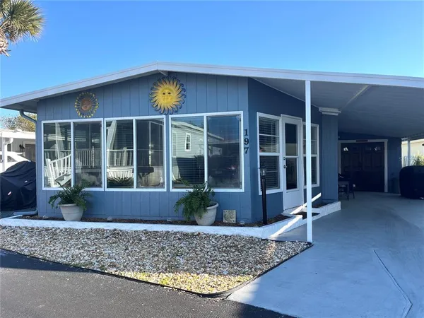 a view of a house with a porch and potted plants