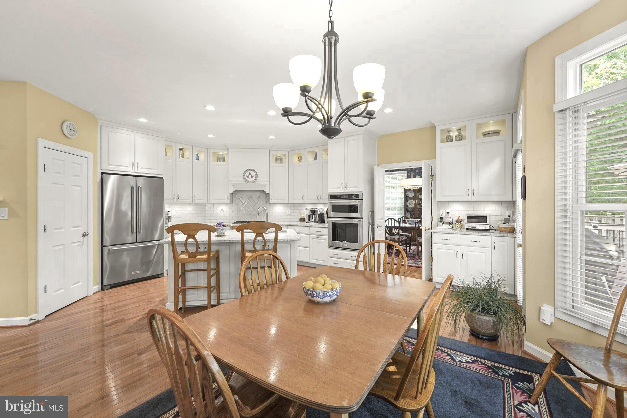 6651 Avignon Boulevard Falls Church, VA 22043 - Photo 18 of 51 a view of a dining room and livingroom with furniture wooden floor a chandelier