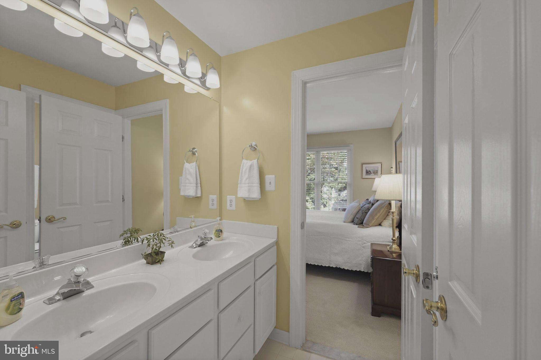 6651 Avignon Boulevard Falls Church, VA 22043 - Photo 31 of 51 a en suite bathroom with a double vanity sink and mirror