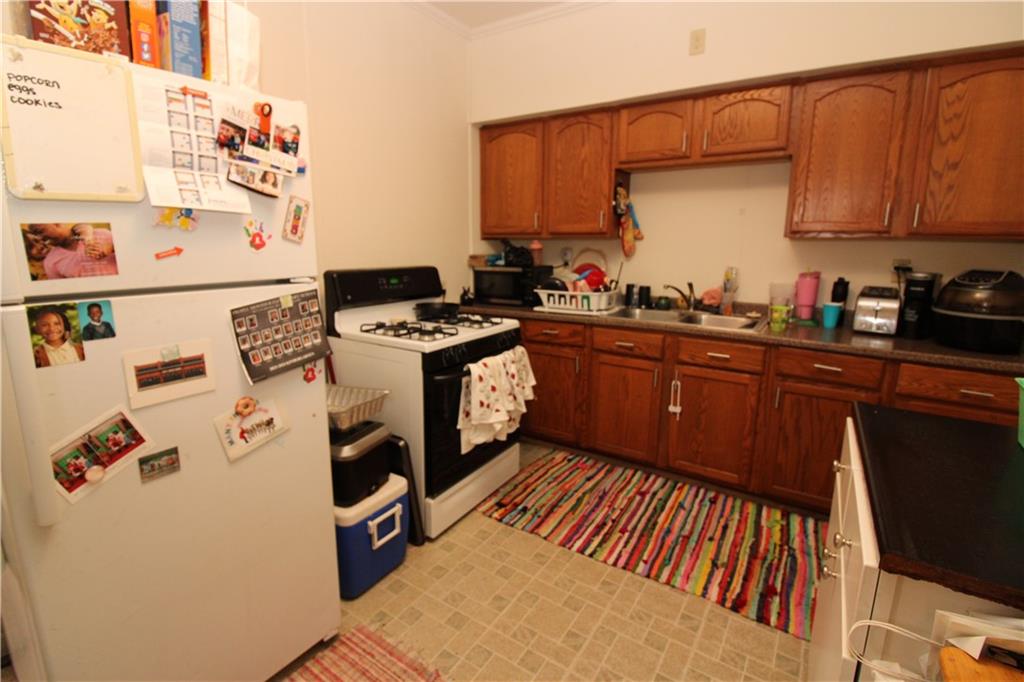 120 Greydon Avenue McKees Rocks, PA 15136 - Photo 9 of 15 a kitchen with stainless steel appliances a stove a sink and a refrigerator