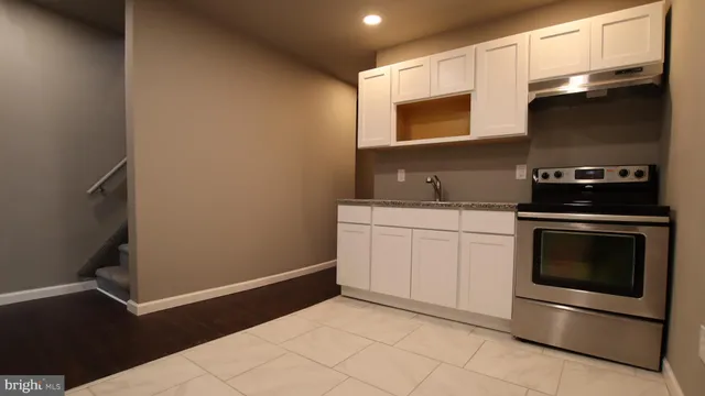a kitchen with a sink and a stove top oven