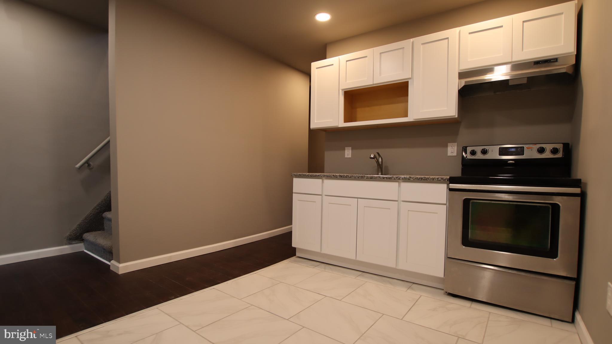 a kitchen with a sink and a stove top oven