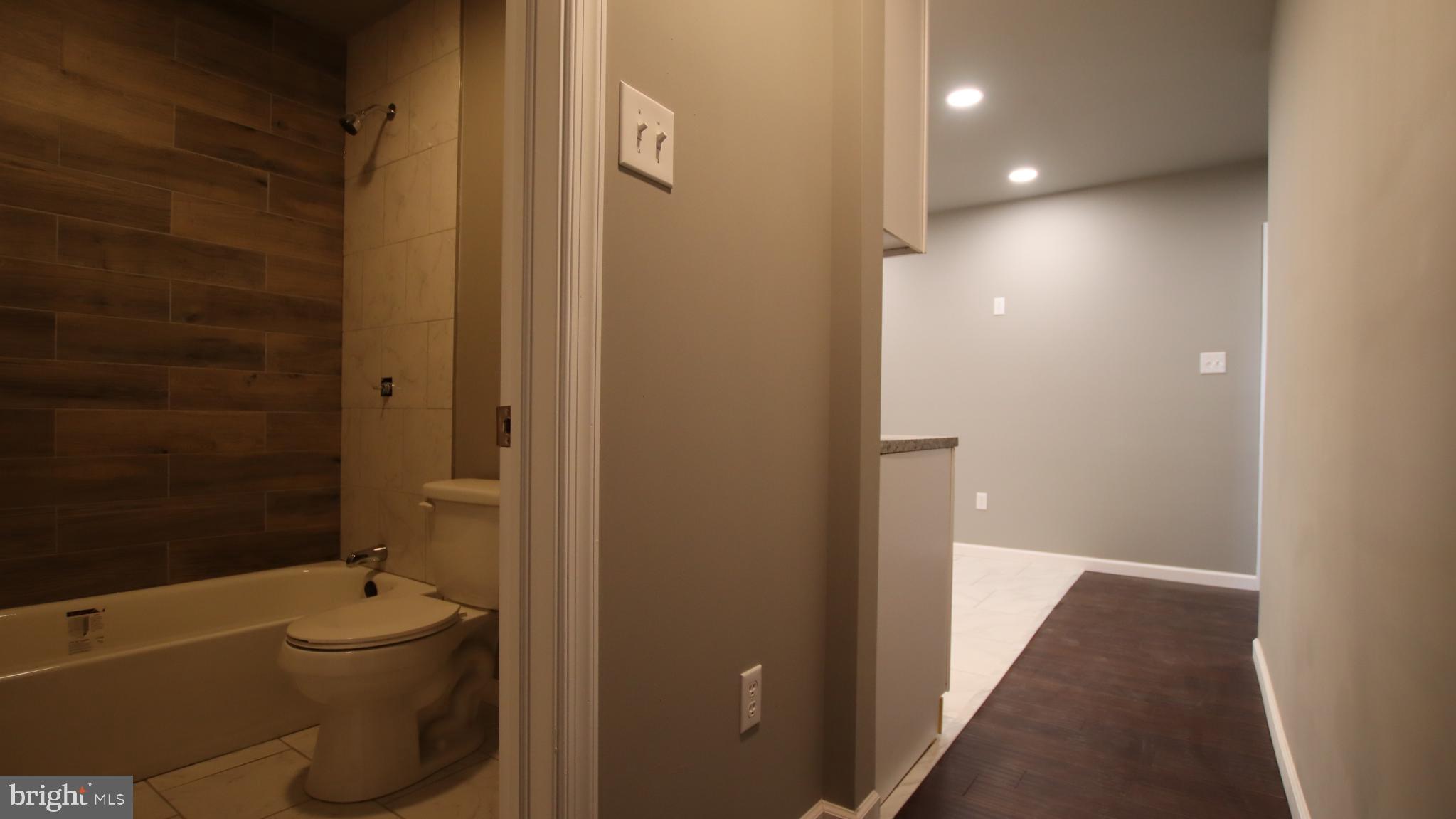 4932 West Thompson Street, Unit 2 Philadelphia, PA 19131 - Photo 12 of 24 a bathroom with a sink a toilet and shower