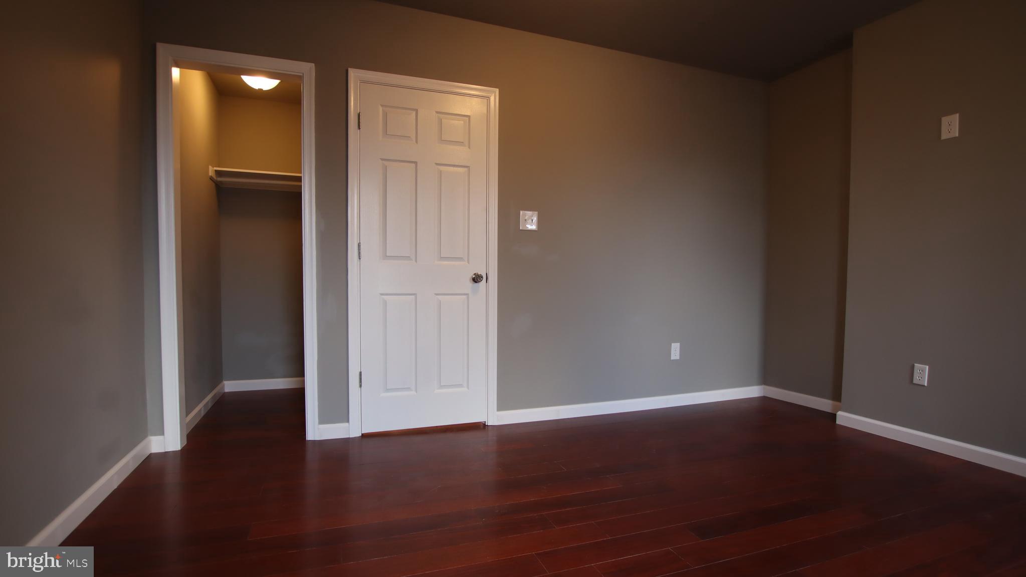 4932 West Thompson Street, Unit 2 Philadelphia, PA 19131 - Photo 23 of 24 an empty room with wooden floor and closet
