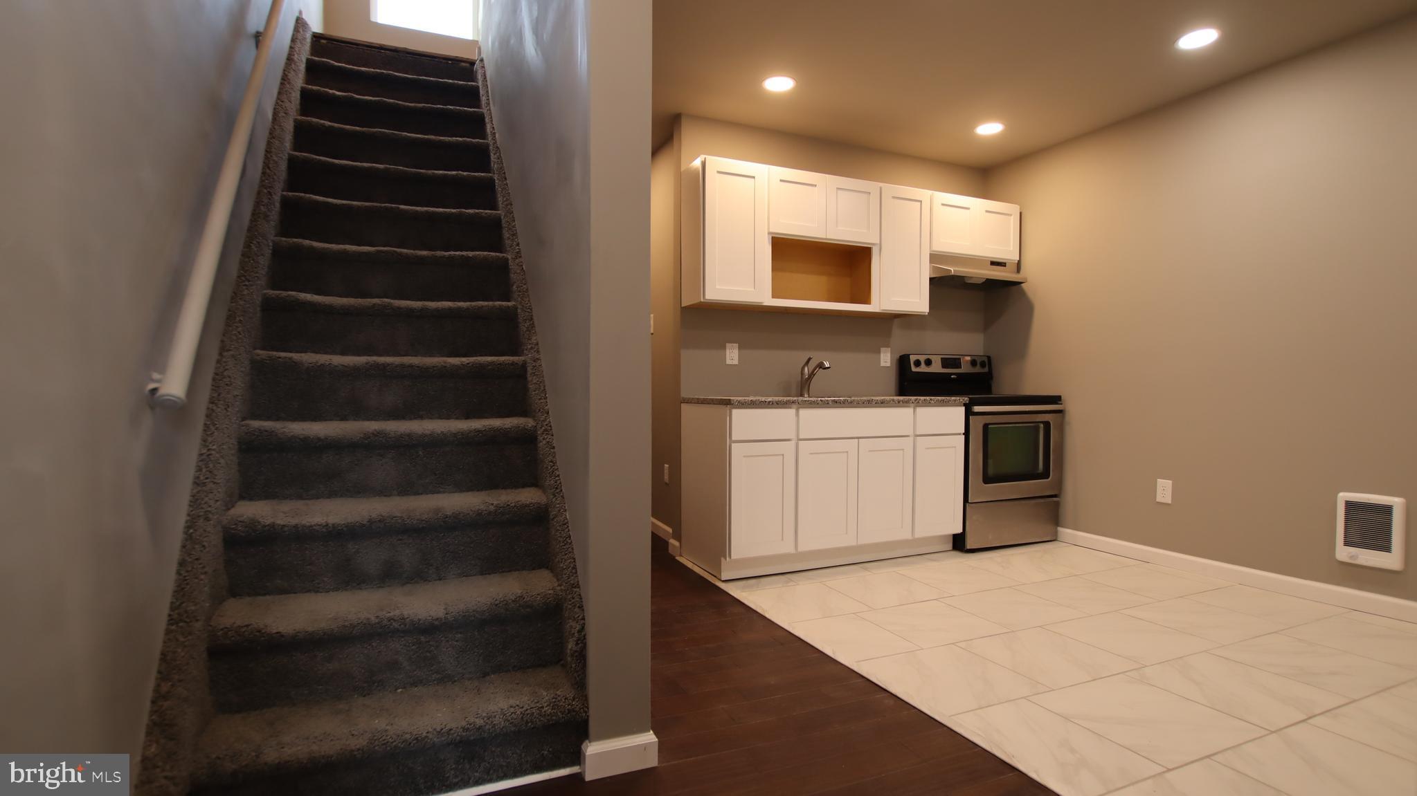 4932 West Thompson Street, Unit 2 Philadelphia, PA 19131 - Photo 8 of 24 a kitchen with cabinets and white appliances