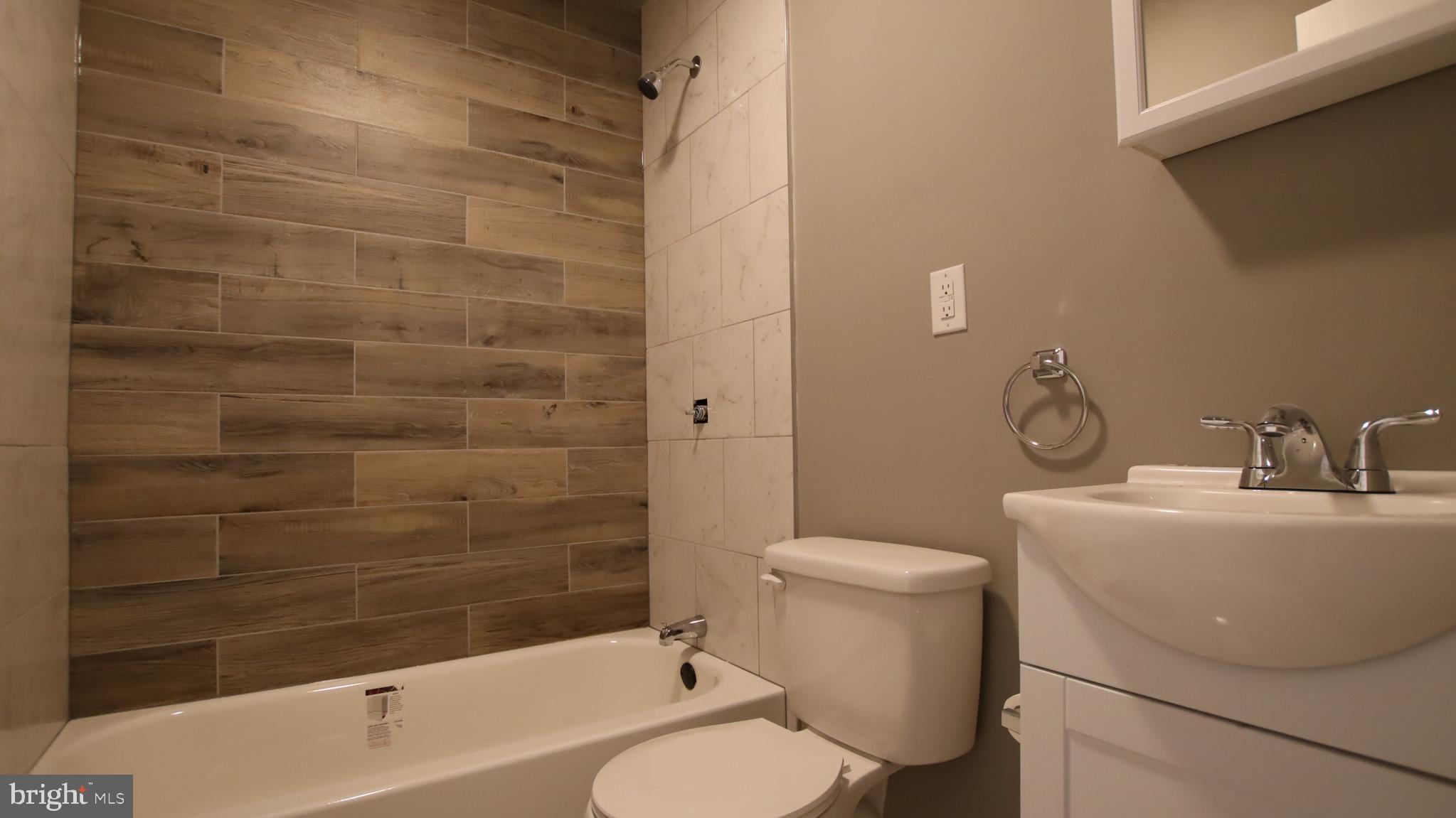4932 West Thompson Street, Unit 2 Philadelphia, PA 19131 - Photo 10 of 24 a bathroom with a sink toilet and shower