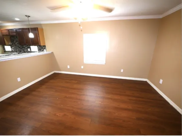 a view of room with window and wooden floor