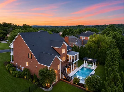 a aerial view of a house with a yard and garden space