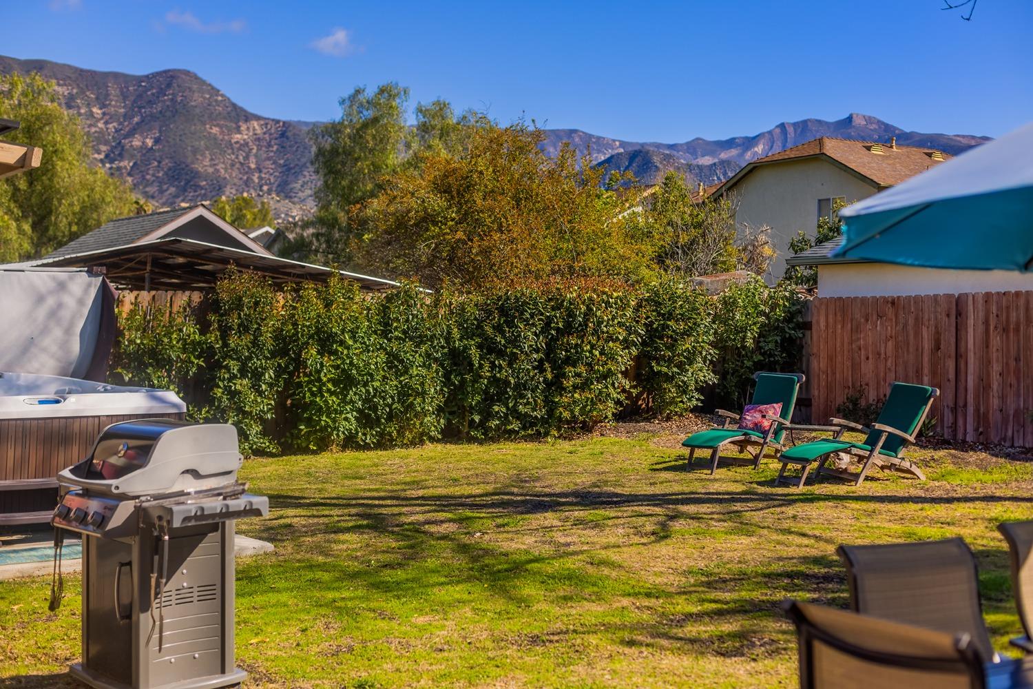 302 Bald Street Ojai, CA 93023 - Photo 20 of 38 a view of a swimming pool with a chairs and table in the patio