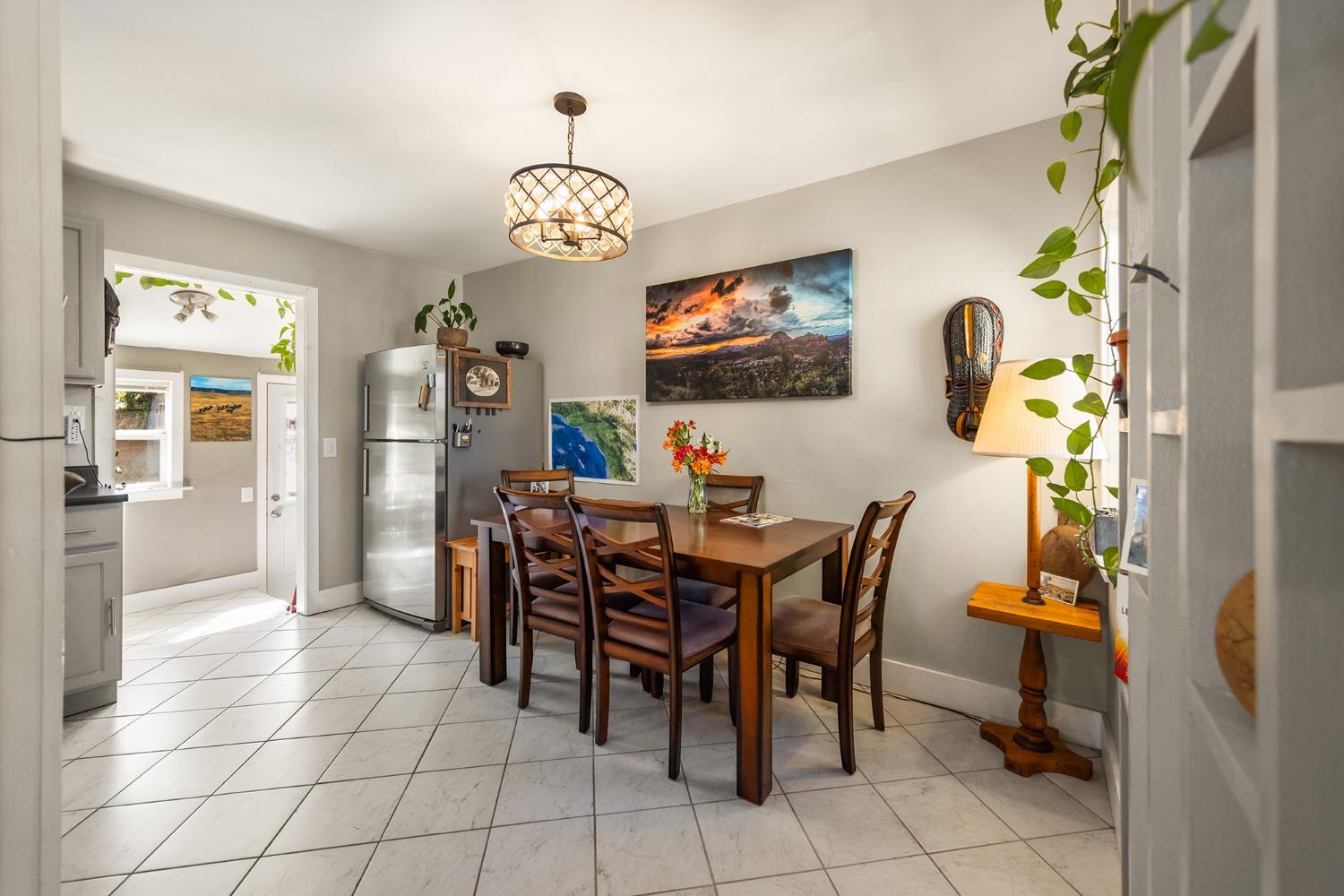302 Bald Street Ojai, CA 93023 - Photo 7 of 38 a view of a dining room and kitchen with furniture a chandelier and a window