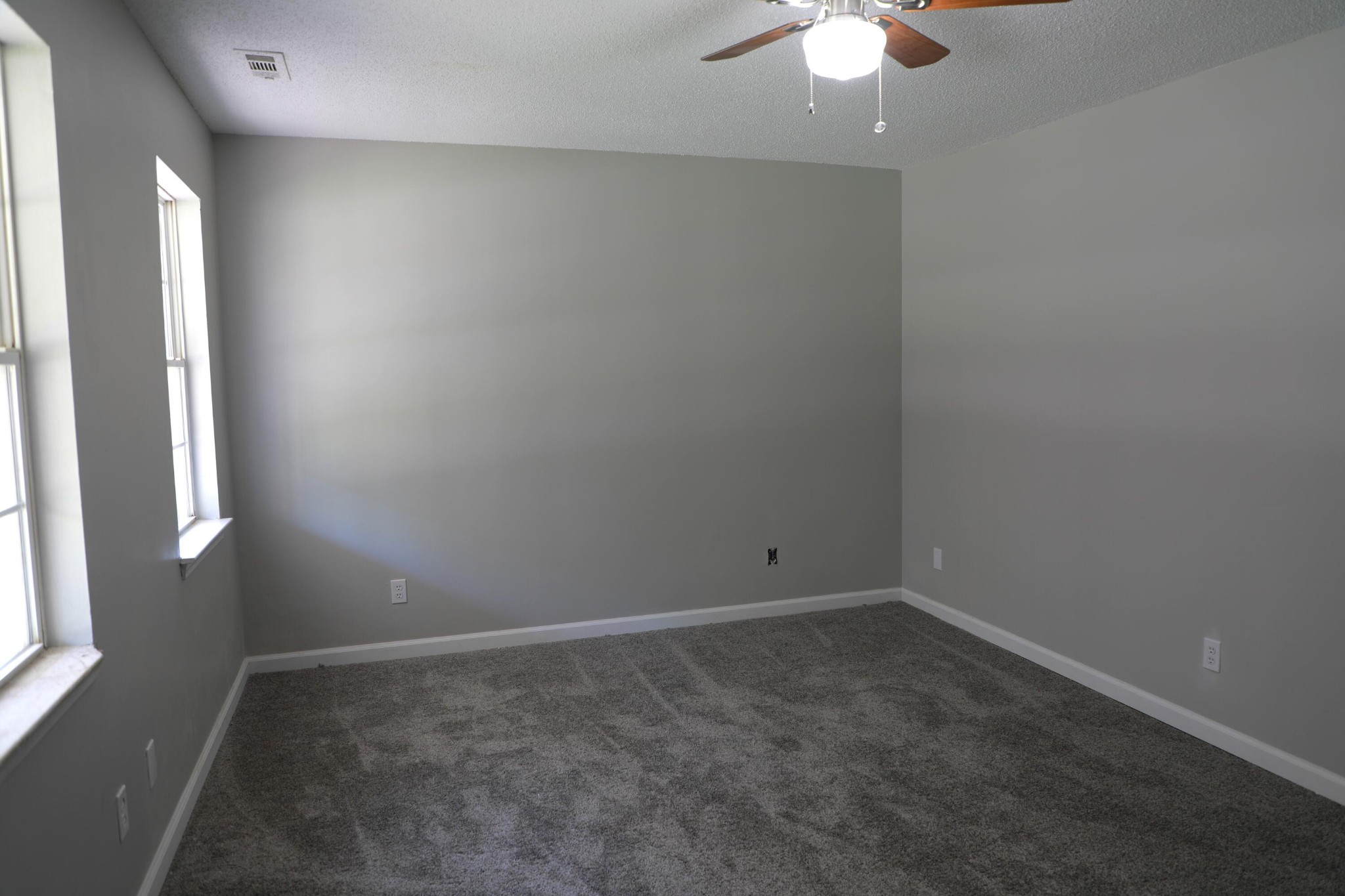 440 Samples Chapel Road Southeast Cleveland, TN 37323 - Photo 18 of 31 an empty room with a chandelier fan and windows