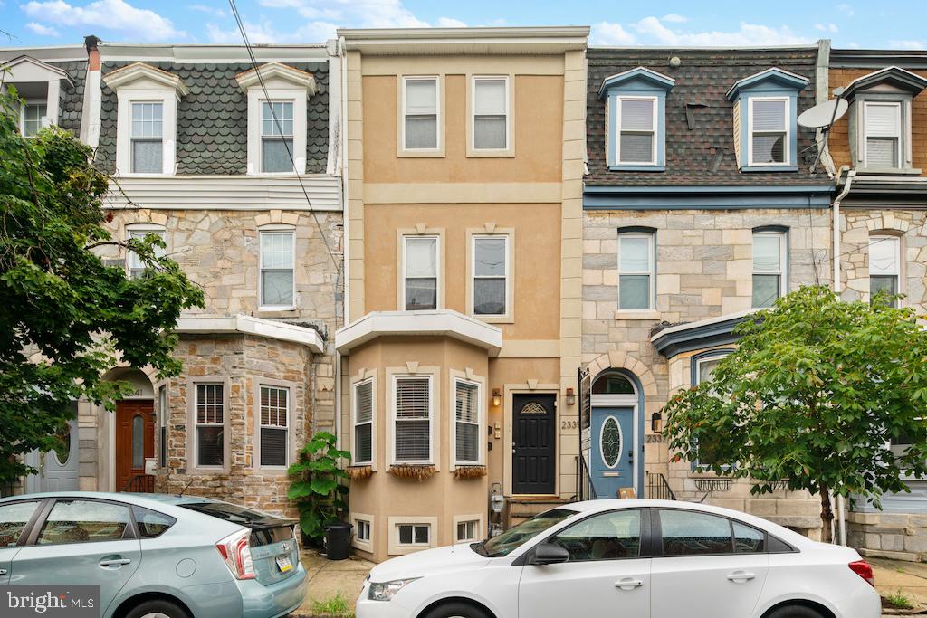 a front view of a residential apartment building with a yard